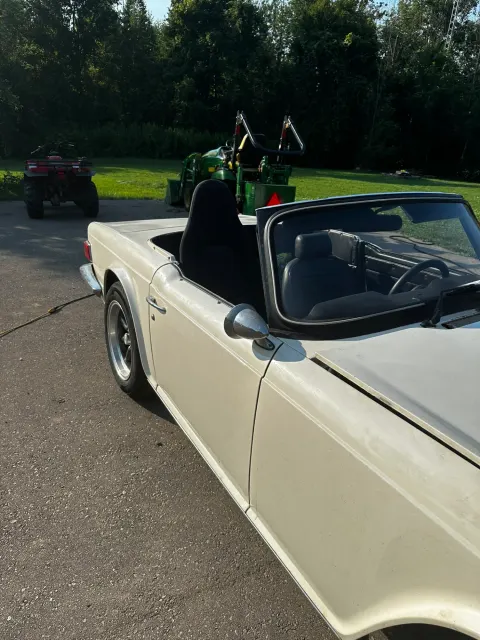 Cream TR6 outdoors before restoration