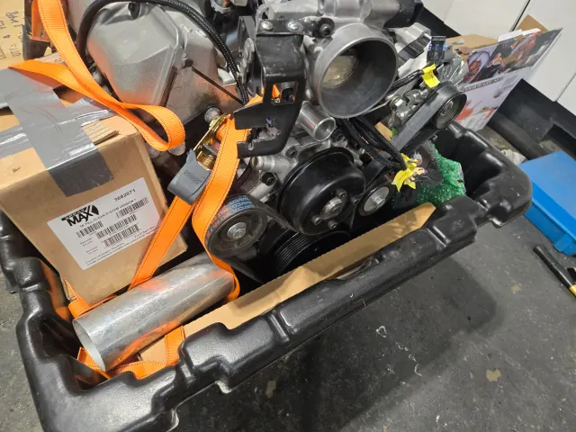 Modern engine strapped in crate with new parts
