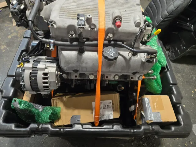 Crated replacement V6 engine strapped for shipping