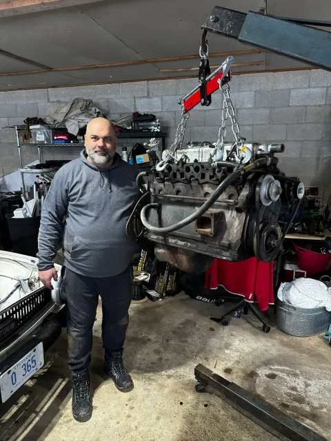 Engine hoisted out on load leveller in garage
