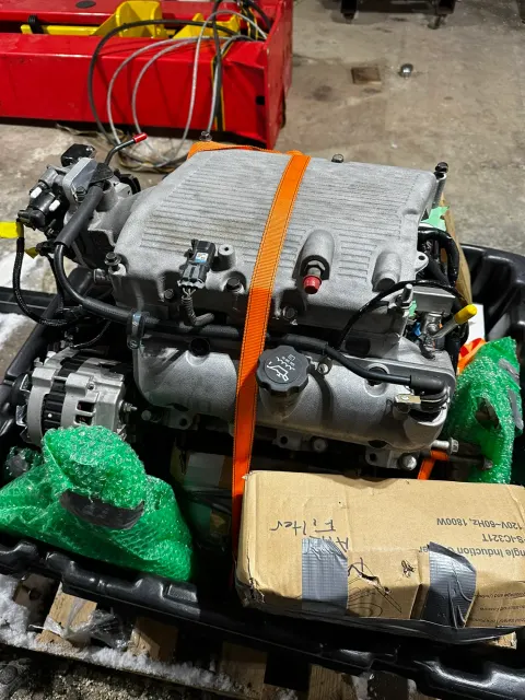 Modern V6 engine strapped to shipping pallet