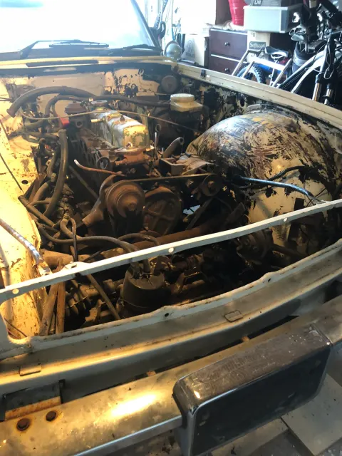 Grimy engine bay before cleanup