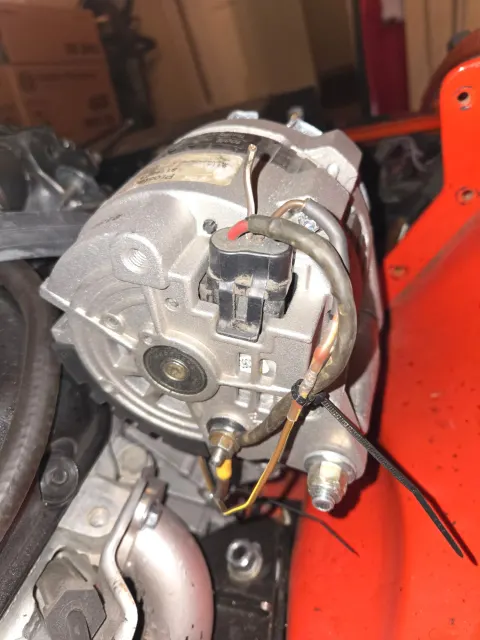 Alternator mounted with wiring plug and cable ties