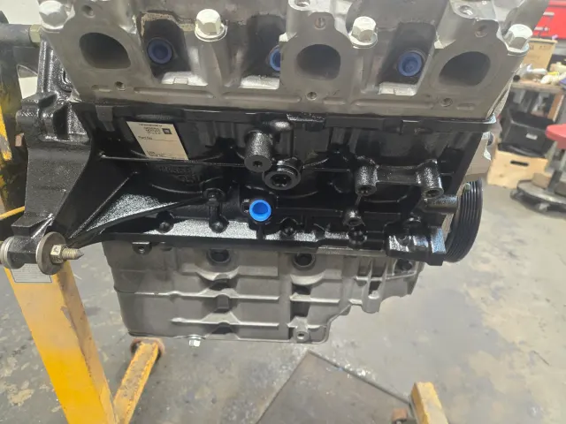 Rebuilt modern four-cylinder engine block on stand