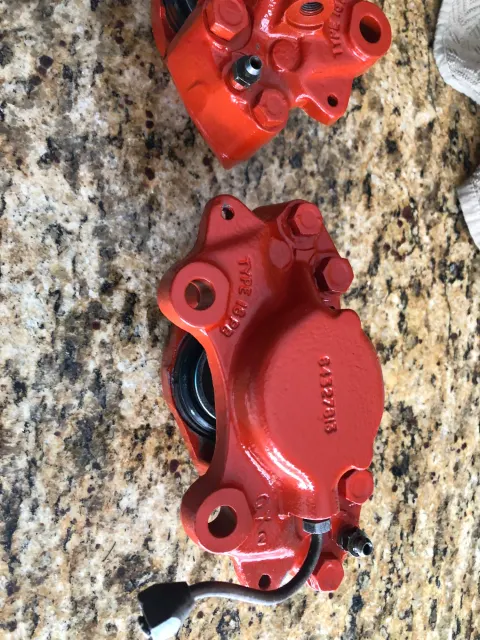Refurbished front brake calipers painted red