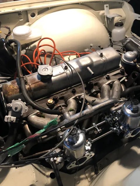 Straight-six engine bay with twin carburettors