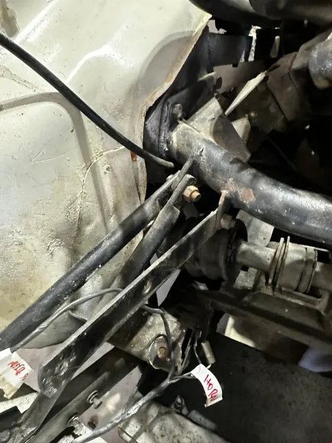 Grimy engine bay bracket and linkage detail