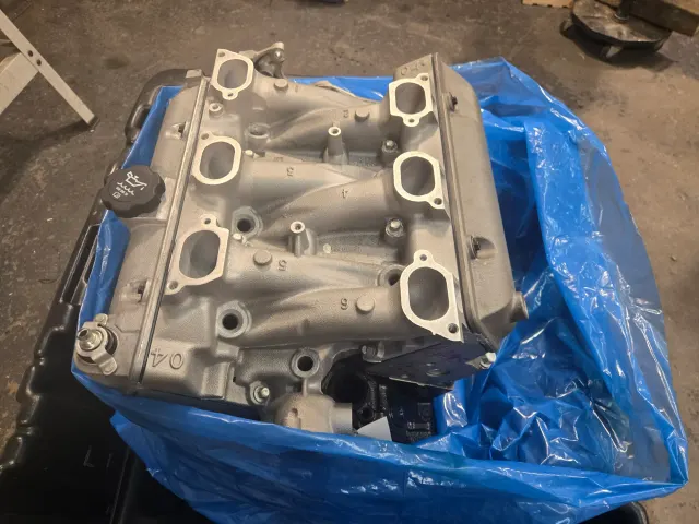 Freshly refinished cylinder head on blue sheeting