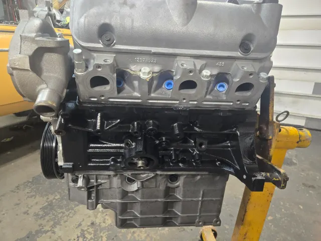 Modern rebuilt four-cylinder engine block on stand