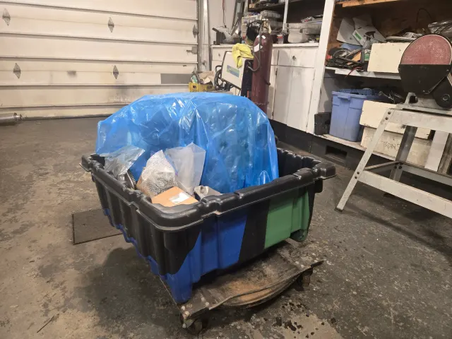 Parts crate on dolly in garage workshop