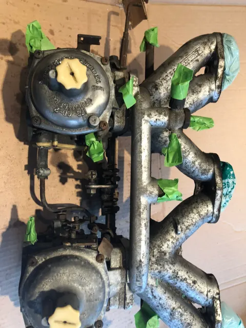 Stripped Stromberg carburettors and inlet manifold masked for blasting