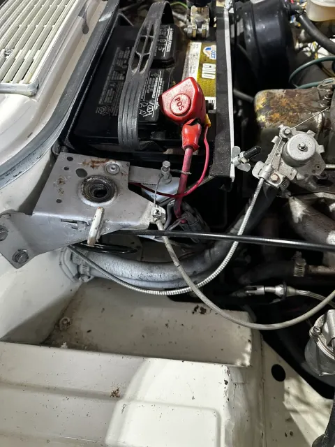 Battery positive terminal and cables in engine bay