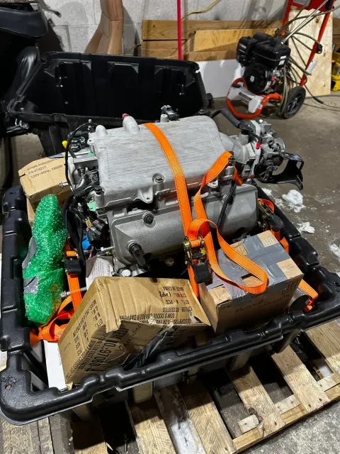 Modern engine strapped in crate on pallet