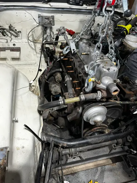 Engine being lifted out with chain hoist