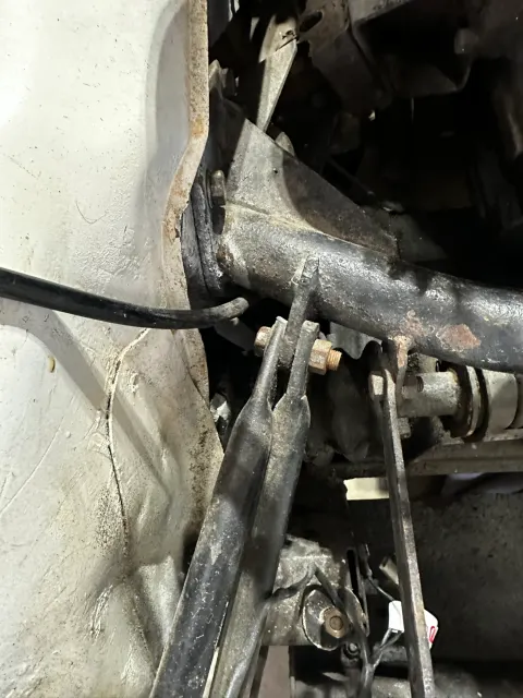 Steering rack and column linkage in engine bay