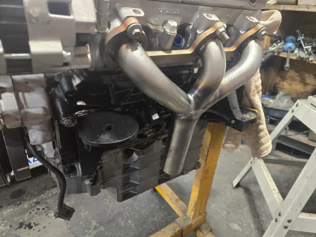 Stainless tubular exhaust manifold fitted to engine block