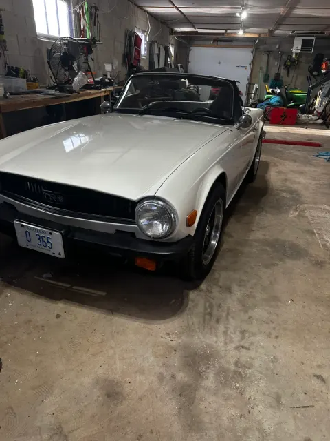 White TR6 roadster parked in garage