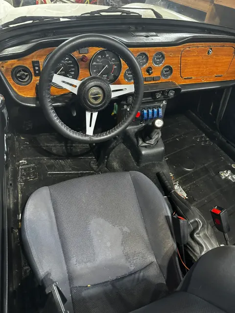 Stripped cockpit with wood dash and rally switch panel