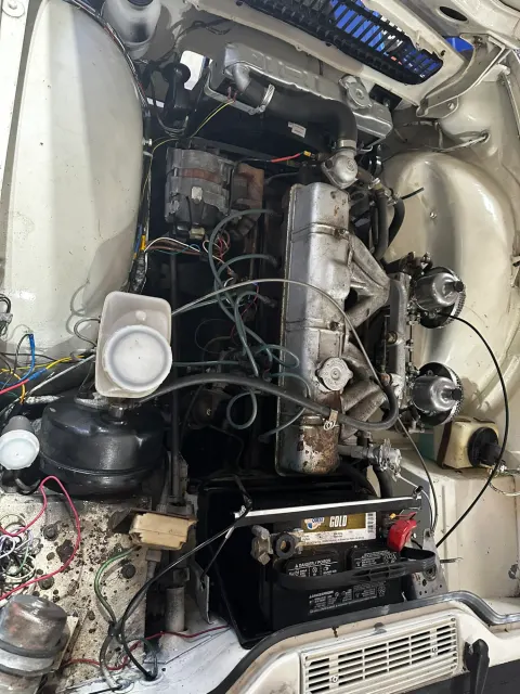 Engine bay with battery and loose wiring