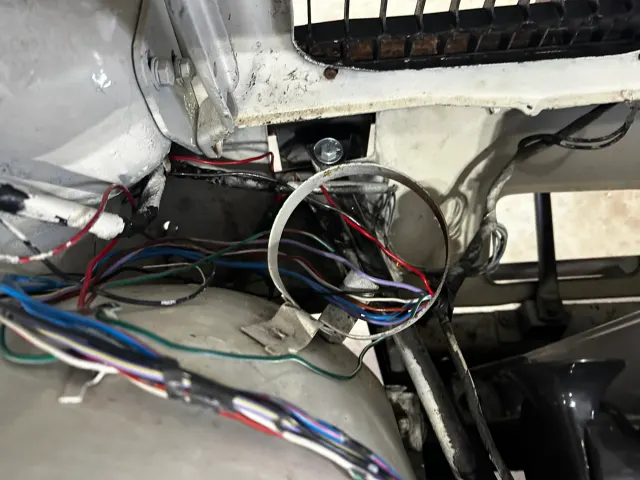 Wiring loom routed through bulkhead in engine bay