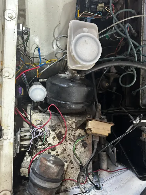 Engine bay bulkhead with brake servo and wiring
