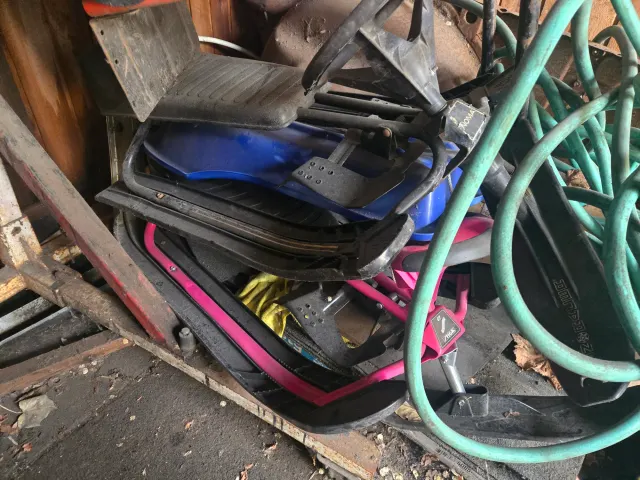 Garage clutter, sledges and hose pipe