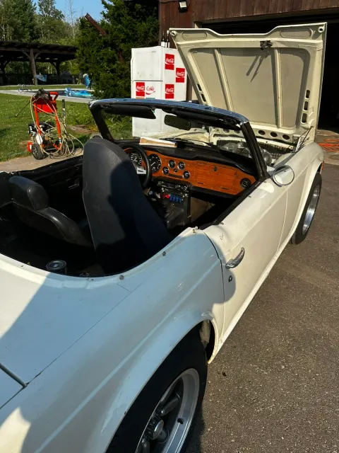 White TR6 with bonnet open in driveway