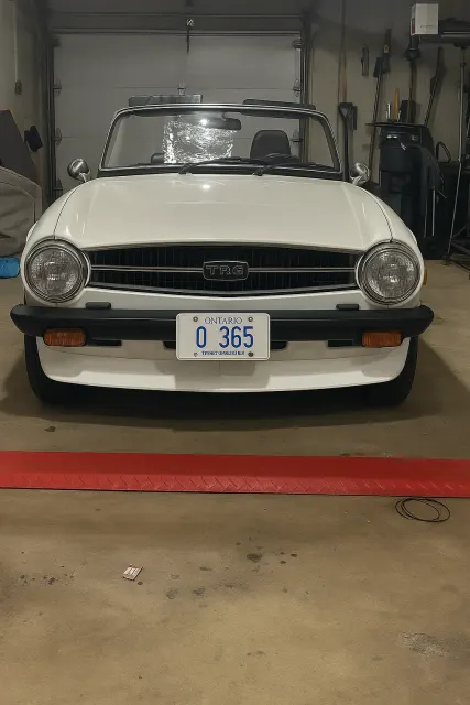 White TR6 front view in garage