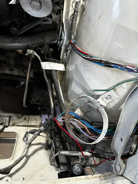Loose wiring harness in engine bay bulkhead