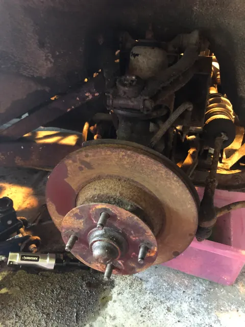 Corroded front hub and brake disc on jack stand