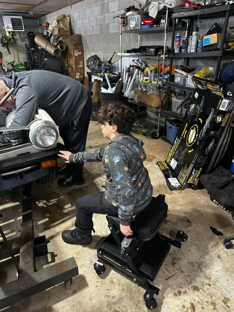 Garage helper on rolling shop seat