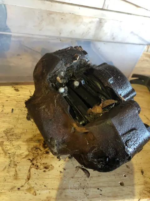 Corroded front brake caliper before cleaning