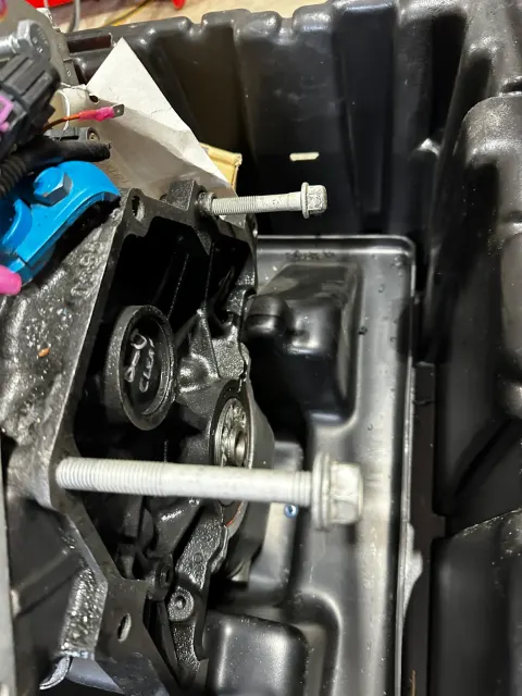 Long bolts fitted through casting inside plastic tray