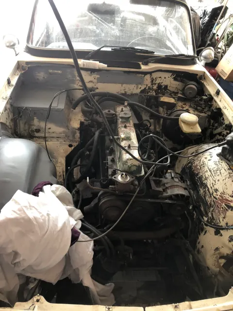 Engine bay before strip-down with inline six in situ