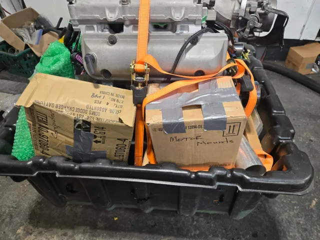 Crated engine strapped to pallet with motor mounts